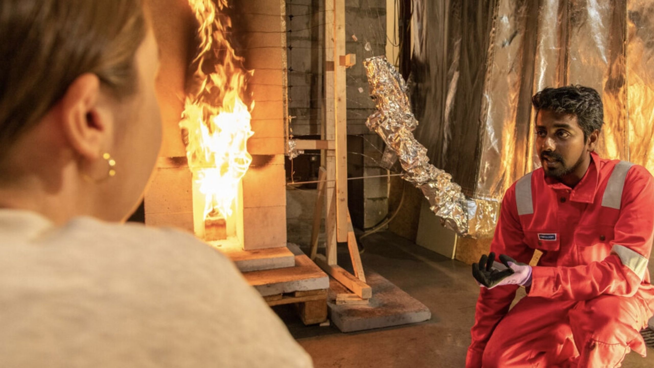 Two people and a small fire.